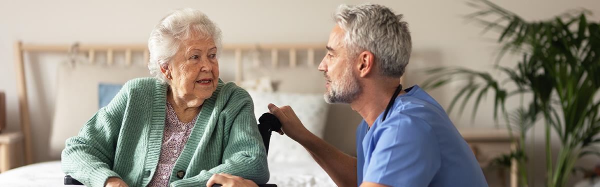 Caregiver doing regular check-up of senior client in her home