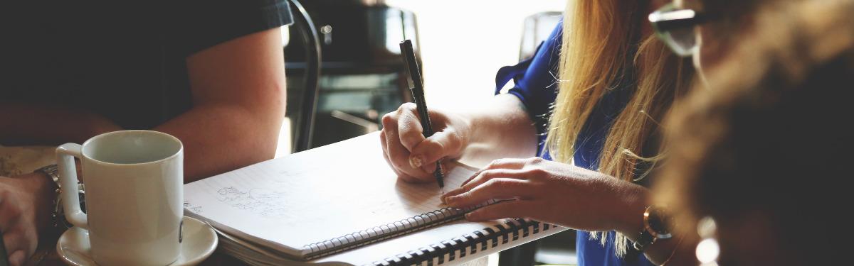 Generic photo of person writing in a notepad